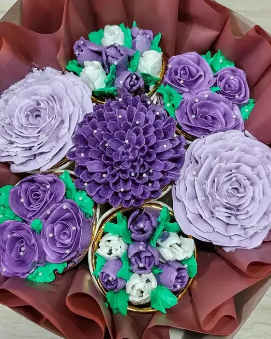 A LexC’s cupcake bouquet with purple and lavender buttercream flowers